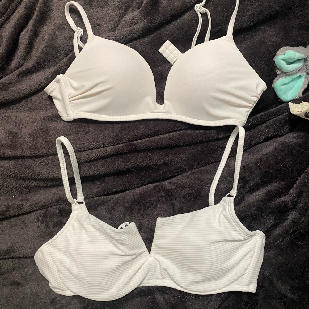 Two white bikini tops